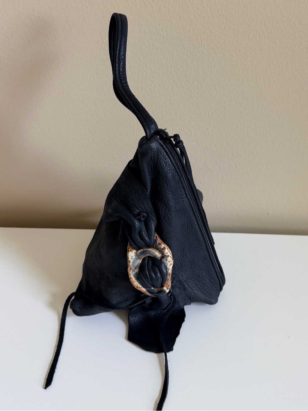 Black Leather Wristlet Bag with Decorative pottery accent